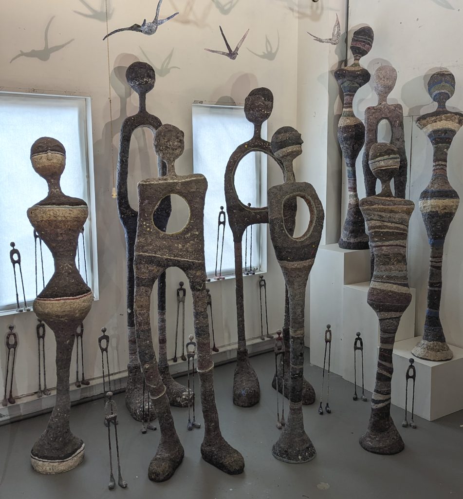 Many sculptures assembles in a studio space